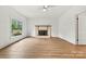 Bright living room with a cozy fireplace and expansive windows at 311 W Center Ave, Mooresville, NC 28115