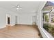 Spacious open-concept living room with hardwood floors and large windows at 311 W Center Ave, Mooresville, NC 28115
