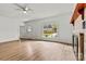 Open living room featuring wood floors, a brick fireplace, and ample natural light at 311 W Center Ave, Mooresville, NC 28115