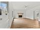 Bright, airy living room with brick fireplace and hardwood-style flooring at 311 W Center Ave, Mooresville, NC 28115