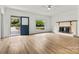 Spacious living room featuring a brick fireplace and modern flooring at 311 W Center Ave, Mooresville, NC 28115