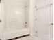 Bathroom featuring a tile shower-tub combo, tile floors, and linen storage at 3911 Granite St, Terrell, NC 28682