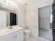 Bright bathroom features a single vanity, toilet, and entryway to the bedroom at 3911 Granite St, Terrell, NC 28682