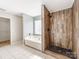 Bright bathroom with separate tub and tile shower including a glass block window for natural light at 3911 Granite St, Terrell, NC 28682