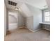 Bedroom features neutral carpeting, a built-in desk, and a door leading to attic storage at 3911 Granite St, Terrell, NC 28682