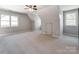 Upstairs bedroom with neutral walls and carpeting plus access to storage and attic doors at 3911 Granite St, Terrell, NC 28682