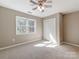 Bedroom with large window offering natural light, complemented by a ceiling fan and closet at 3911 Granite St, Terrell, NC 28682