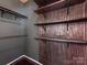 Walk-in closet showcasing custom wood shelving and a dark painted wall with modern rod fixture at 3911 Granite St, Terrell, NC 28682