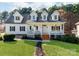 Charming two-story home featuring a manicured lawn, flowering trees and a welcoming front porch at 3911 Granite St, Terrell, NC 28682