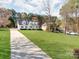 Beautiful two-story home with a long driveway and lush green lawn, surrounded by mature trees at 3911 Granite St, Terrell, NC 28682