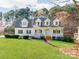 Charming two-story home featuring a manicured lawn, flowering trees and a welcoming front porch at 3911 Granite St, Terrell, NC 28682