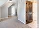 Upstairs hallway featuring neutral carpeting and access to tiled secondary rooms at 3911 Granite St, Terrell, NC 28682