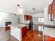 Open kitchen with stainless appliances, granite countertops, and hardwood floors at 3911 Granite St, Terrell, NC 28682