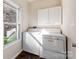 Functional laundry room with washer, dryer, storage cabinet, and natural light from a window at 3911 Granite St, Terrell, NC 28682