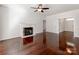 Inviting living room featuring a fireplace, hardwood floors, and a ceiling fan for added comfort at 3911 Granite St, Terrell, NC 28682