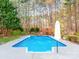 Beautiful backyard pool area with fountains and mature trees creating a serene, private setting at 3911 Granite St, Terrell, NC 28682