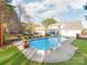 Inviting backyard pool area with a rock feature, fountains, and well-maintained landscaping at 3911 Granite St, Terrell, NC 28682