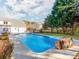 Beautiful backyard pool area with fountains and mature trees creating a serene, private setting at 3911 Granite St, Terrell, NC 28682