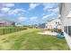 Backyard includes lush green lawn, metal fencing, patio with swing and outdoor furniture at 4630 Bent Green Ln, Monroe, NC 28112