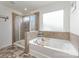 Modern bathroom featuring a soaking tub and separate glass shower at 4630 Bent Green Ln, Monroe, NC 28112