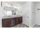 Bathroom with double sink vanity with dark wood cabinets and large wall mirror at 4630 Bent Green Ln, Monroe, NC 28112
