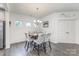 Charming dining area with decorative wainscoting and modern chandelier at 4630 Bent Green Ln, Monroe, NC 28112
