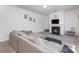 Cozy living room featuring a fireplace, neutral sectional sofa, and minimalist decor, creating an inviting atmosphere at 4630 Bent Green Ln, Monroe, NC 28112