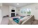 Bright living room with a fireplace, large windows, and a comfy sectional sofa, perfect for relaxation at 4630 Bent Green Ln, Monroe, NC 28112