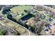 An aerial shot of a property with multiple outbuildings, a well-defined perimeter, and ample green space at 4875 Sulpher Springs Ne Rd, Hickory, NC 28601