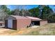Exterior view of a spacious barn with a large roll-up door and open bay for equipment or vehicle storage at 4875 Sulpher Springs Ne Rd, Hickory, NC 28601