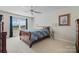 Comfortable bedroom with a large window, warm lighting, and a plush bed with patterned bedding at 4875 Sulpher Springs Ne Rd, Hickory, NC 28601