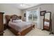 Cozy bedroom featuring a decorative wooden headboard, lots of natural light, and neutral carpet at 4875 Sulpher Springs Ne Rd, Hickory, NC 28601