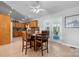 Bright eat-in kitchen with wood table and chairs, oak cabinets, and views into the sunroom and kitchen at 4875 Sulpher Springs Ne Rd, Hickory, NC 28601