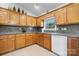 Well-maintained kitchen with oak cabinets, laminate countertops, and modern white appliances at 4875 Sulpher Springs Ne Rd, Hickory, NC 28601