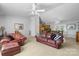 Spacious living room showcasing a leather sofa, armchair, and view into the dining area and kitchen at 4875 Sulpher Springs Ne Rd, Hickory, NC 28601