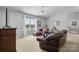 Cozy living room with a large window, leather furniture set, and neutral carpet at 4875 Sulpher Springs Ne Rd, Hickory, NC 28601
