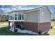Home exterior featuring a brick foundation, enclosed sunroom, and access to the backyard at 4875 Sulpher Springs Ne Rd, Hickory, NC 28601