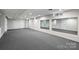 Large, unfinished basement with carpet flooring and mirrored wall at 500 Lansdowne Rd, Charlotte, NC 28270