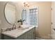 Bright bathroom with double sinks, marble countertops, and a glass block window at 500 Lansdowne Rd, Charlotte, NC 28270