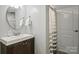 Bathroom with a modern vanity, round mirror and shower featuring a neutral curtain at 500 Lansdowne Rd, Charlotte, NC 28270