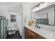 Stylish bathroom featuring black hexagon floor tile, wood vanity, and modern fixtures at 500 Lansdowne Rd, Charlotte, NC 28270