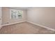 Bedroom with plush carpeting, a bright window, and neutral walls at 500 Lansdowne Rd, Charlotte, NC 28270