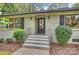 Inviting front entrance featuring a stylish front door, brick steps, and fresh landscaping at 500 Lansdowne Rd, Charlotte, NC 28270