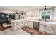 Bright kitchen featuring white cabinetry, an island, stainless steel appliances, and stylish lighting fixtures at 500 Lansdowne Rd, Charlotte, NC 28270