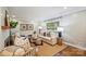 Bright living room featuring hardwood floors, large windows, and stylish furniture at 500 Lansdowne Rd, Charlotte, NC 28270