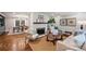 Cozy living room featuring a brick fireplace, hardwood floors, and comfortable seating at 500 Lansdowne Rd, Charlotte, NC 28270