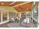 Charming screened porch with brick fireplace and comfortable seating at 500 Lansdowne Rd, Charlotte, NC 28270