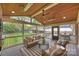 Inviting screened porch offers a cozy seating area and backyard views at 500 Lansdowne Rd, Charlotte, NC 28270