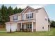 Charming two-story home featuring beige siding, dark shutters, and a welcoming front porch at 5703 Skinny Dr, Charlotte, NC 28215