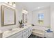 Bathroom featuring dual vanities, framed mirrors, a soaking tub, and views of the property at 620 St Lukes Church Rd, Salisbury, NC 28146